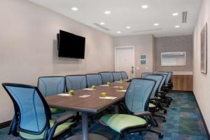 a conference room with a long table and chairs at Home2 Suites By Hilton Fayetteville North in Fayetteville +34 photos