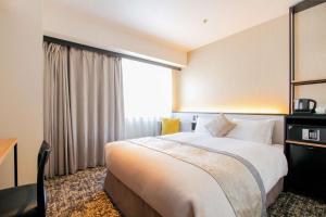 سرير أو أسرّة في غرفة في Best Western Plus Nagoya Sakae