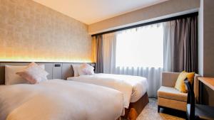 سرير أو أسرّة في غرفة في Best Western Plus Nagoya Sakae