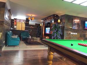 a billiard room with a pool table and a tv at Luxury Villa in Rehab City in Cairo