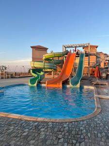 a water park with a slide in a pool at شالية ارضى مميز فى السخنة in Ain Sokhna