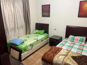 a bedroom with two twin beds and a window at شالية ارضى مميز فى السخنة in Ain Sokhna