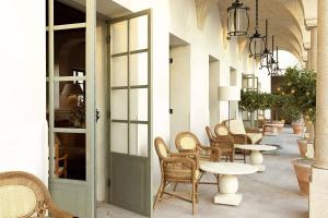 a row of chairs and tables in a hallway at Hôtel du Couvent, a Luxury Collection Hotel, Nice in Nice