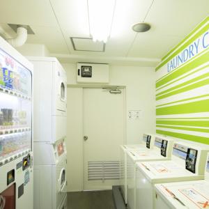 a store with refrigerators and a door in a room at FLEXSTAY INN Kawasaki Kaizuka in Kawasaki