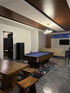 a room with a pool table and a couch at Bwalk Hotel & Villa Malang in Sengkaling