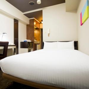 Postel nebo postele na pokoji v ubytování FLEXSTAY INN Kawasaki Kaizuka