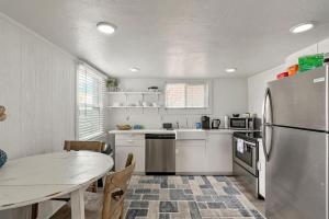 a kitchen with a table and a stainless steel refrigerator at Central Location Walking Distance to Restaurants in Provo