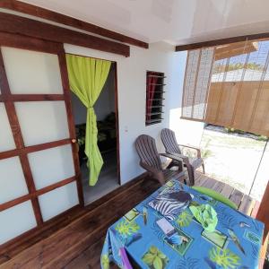 a room with a table and two chairs and a window at Nuutea lodge 2 in Avatoru