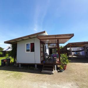 a small house with a porch and a deck at Nuutea lodge 2 in Avatoru