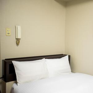 Postel nebo postele na pokoji v ubytování FLEXSTAY INN Kawasaki Kaizuka