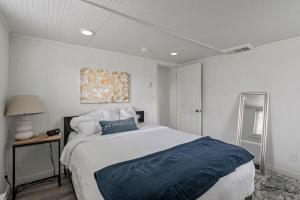 a bedroom with a large white bed with blue sheets at Cozy Home Close to Provo Airport in Provo