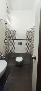 a bathroom with a toilet and a sink at Stayz Inn Hotels - T nagar Chennai Near Pondy Bazzar in Chennai