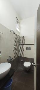 a bathroom with a toilet and a sink at Stayz Inn Hotels - T nagar Chennai Near Pondy Bazzar in Chennai
