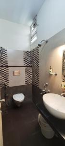 a bathroom with a sink and a toilet at Stayz Inn Hotels - T nagar Chennai Near Pondy Bazzar in Chennai