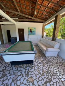 a living room with a pool table and a couch at Sítio Curumim - Zohra in Itaparica