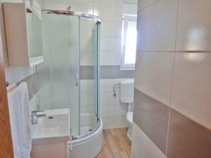 a bathroom with a glass shower and a toilet at Apartment in Starigrad-Paklenica 38616 in Starigrad