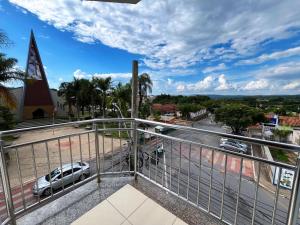a balcony with a view of a street and a church at Hotel Mirante in Inhaúma
