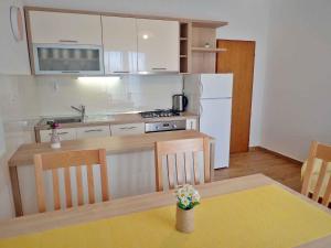 a small kitchen with a table and a counter top at Apartments Seline/Paklenica Riviera 36550 in Seline