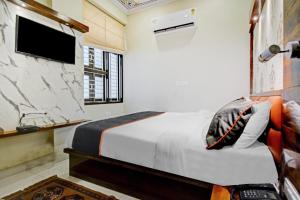 מיטה או מיטות בחדר ב-Hotel Tejesvi