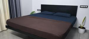 a bed with two pillows on it in a bedroom at UnnisHome in Adūr