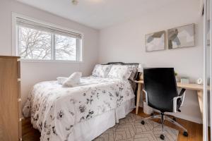 a bedroom with a bed and a desk and a chair at Eglinton West Guest Suite in Toronto