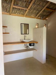 a bathroom with a sink and a mirror on the wall at Casa Terra in Paso Hondo