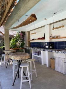 a kitchen with a table and some stools in it at Casa Terra in Paso Hondo
