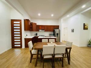 a kitchen with a wooden table and white chairs at Casa Nefertari in Flores +11 photos