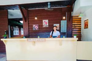 a woman standing behind a counter in a restaurant at Anaya Inn and Restobar in Panglao Island