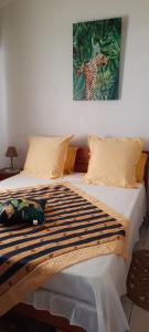 a bed with a cheetah painting on top of it at Villa confortable avec vue mer à Petit-Canal in Petit-Canal