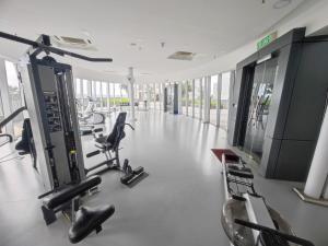 a gym with several treadmills and cardio machines at Wan's Homestay i-City in Shah Alam