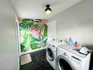 a washing machine in a laundry room with a mural at Carmen’s Casita in Tampa