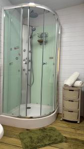 a shower with a glass door in a bathroom at La Cabaña Punta Negra in Punta Colorada +9 photos