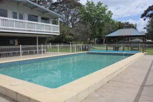 a swimming pool with a fence and a gazebo at Beach Park Phillip Island - Apartments in Cowes