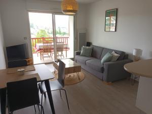 a living room with a couch and a table at Appartement Hendaye, 2 pièces, 4 personnes - FR-1-239-777 in Hendaye
