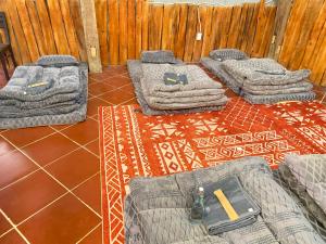 a group of mattresses sitting on the floor next to a fence at COI NGUON FARM GLAM Mang Den in Kon Von Kla