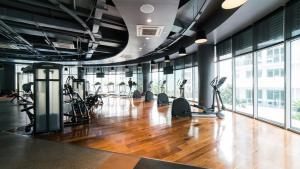 a gym with treadmills and exercise equipment and windows at Great for Staycation for Family in Azure Beach in Tanza