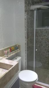 a bathroom with a toilet and a glass shower at São Salvador Guest House in Salvador