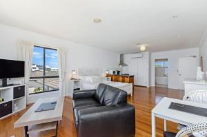 a large living room with a couch and a bed at Clifftop Apartments Portland Vic in Portland