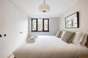 a large white bed in a room with a window at Hausd - Covent Garden in London