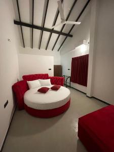 a bedroom with a large bed with red pillows at Happy villa (tuvaraga) 