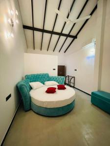 a bedroom with a large bed and a blue couch at Happy villa (tuvaraga) 