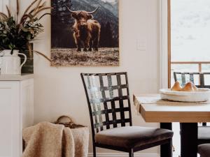 a dining room with a picture of a bull on the wall at Mountview Alpaca Farmhouse in Canungra