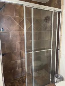 a shower with a glass door in a bathroom at Field Stone in Oklahoma City