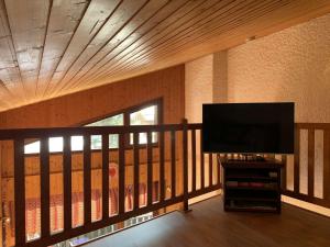 a living room with a flat screen tv on a balcony at Appartement Le Grand-Bornand, 3 pièces, 5 personnes - FR-1-458-198 in Le Grand-Bornand