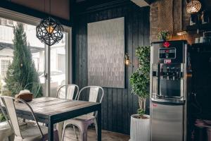 a dining room with a table and a refrigerator at Original House in Chishang