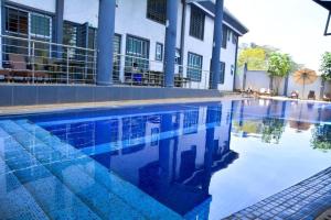 a swimming pool in front of a building at Relax on the high-end space in Nairobi