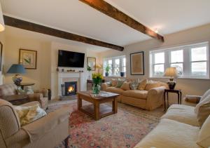 a living room with couches and a fireplace at Davis Gate Farmhouse in Ribchester