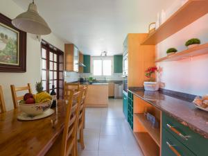 a kitchen with a table with a bowl of fruit on it at El Jardin de Santa Brígida with private pool, sauna & jacuzzi in Santa Brígida