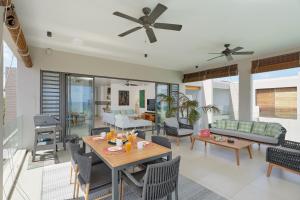 a living room with a table and chairs at Otera 2 Penthouse with panoramic view by LOV in Trou aux Biches